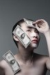 Woman with cosmetic surgery markings and banknotes sticking her face and shoulder