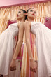 Woman in white dress leaning against mirror