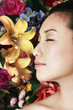Woman posing in front of floral background