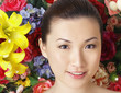 Woman posing in front of floral background
