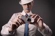 Woman with rhinestones on her lips taking picture with digital camera