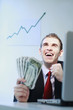 Businessman smiling while holding banknotes