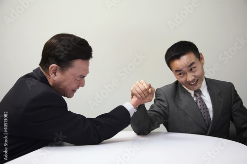 Photo: Businessmen arm wrestling Businessmen arm wrestling