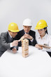 Business people playing wooden blocks game