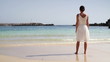 Video: Woman in white dress standing on beautiful tropical beach Woman in white dress standing on beautiful tropical beach