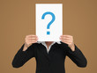 Photo: businesswoman holding question mark sign in head businesswoman holding question mark sign in head