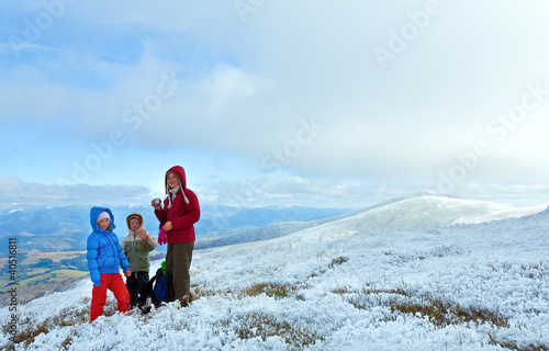 Photo: Family on autumn mountain plateau with first winter snow Family on autumn mountain plateau with first winter snow