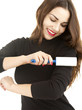 young woman cleaning dust with lint roller