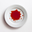 Red splatter on white dish