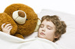 Boy sleeping with toy bear