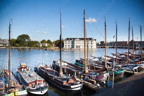 Photo: old boats at the bank of Amsterdam's canal old boats at the bank of Amsterdam's canal