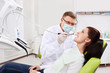 Photo: The dentist treats teeth of patient The dentist treats teeth of patient