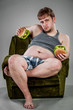 fat man eating hamburger
