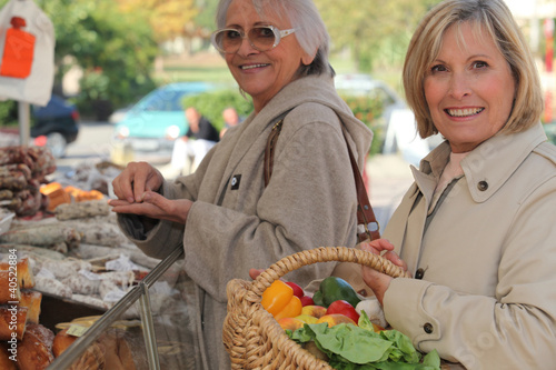 Photo: Mother and daughter shopping at the market together Mother and daughter shopping at the market together