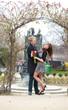 Dating couple hugging under beautiful arch
