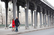 Romantic couple walking on the Bir-Hakeim bridge in Paris