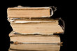 Pile of old books on black