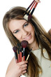 The beautiful girl with brushes for a make-up