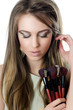 The beautiful girl with brushes for a make-up