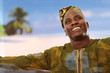 Photo: A smiling black man on the beach is looking upwards A smiling black man on the beach is looking upwards