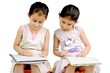 Two Indian kids studying at home.