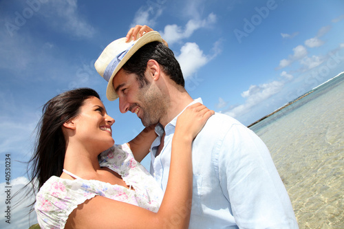 Photo: Couple of lovers embracing each other at the beach Couple of lovers embracing each other at the beach