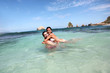Cheerful couple swimming in the ocean