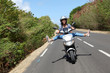 Young woman riding motorbike