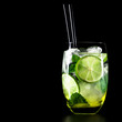 Mojito cocktail on black background with lime and mint with copy