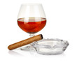 Photo: Cognac in glass with cigar and ashtray isolated Cognac in glass with cigar and ashtray isolated
