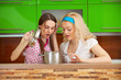Girls looking at a meal in a pot Girls looking at a meal in a pot