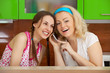 Two friends on kitchen get a phone call Two friends on kitchen get a phone call