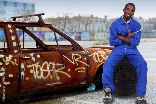 Photo: Urban mechanic with a graffitied car Urban mechanic with a graffitied car