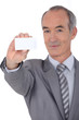 canvas print picture - Man holding business card