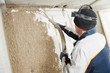 Plasterer at stucco work with liquid plaster Plasterer at stucco work with liquid plaster