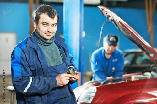 Photo: happy mechanic technician at service station happy mechanic technician at service station