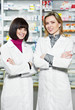 Photo: Two Pharmacy chemist women in drugstore Two Pharmacy chemist women in drugstore