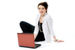 Young woman smiling sitting on the floor with laptop