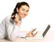 A young woman lying on the floor with a laptop