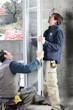 Two men installing new windows