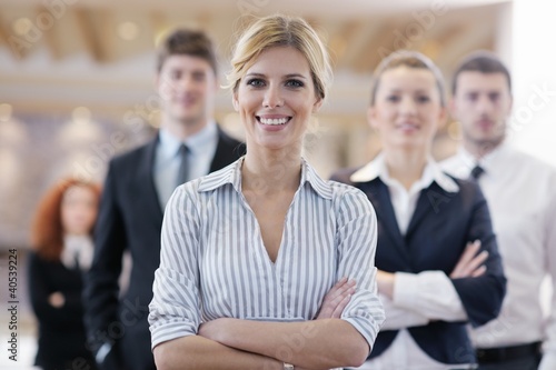 Photo: business woman standing with her staff at conference business woman standing with her staff at conference