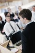 Young  business man giving a presentation on conference