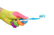 Colored hand holding toothbrush with toothpaste.