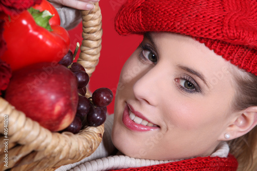 Photo: Woman holding fruit basket Woman holding fruit basket