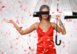 Pretty woman under umbrella with petals around her