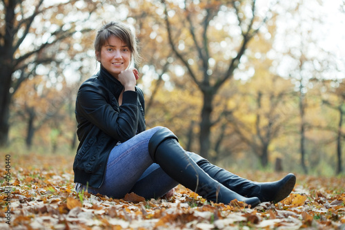 Photo: Girl in knee-high boots at autumn park Girl in knee-high boots at autumn park