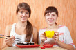 women eating sushi rolls women eating sushi rolls
