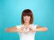 woman smiling making heart shape with hands woman smiling making heart shape with hands