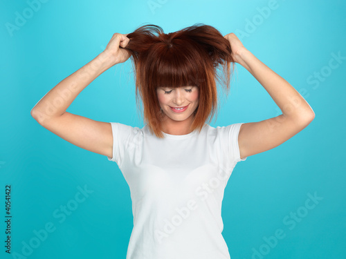 Photo: attractive woman pulling her hair attractive woman pulling her hair