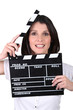 Brunette woman with movie slate